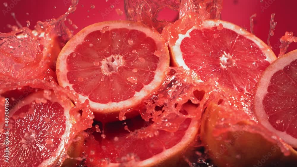 Slow Motion Shot of Grapefruit Juice Splashing through Grapefruit Slices Slow Motion Shot of Grapefruit Juice Splashing through Grapefruit Slices