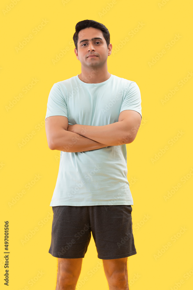 Portrait of young man in sports wear looking at camera with arms folded Portrait of young man in sports wear looking at camera with arms folded