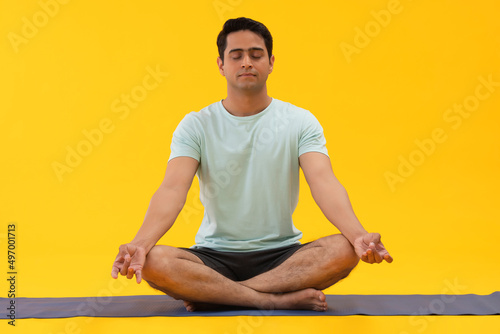 Portrait of a young man meditating at home
