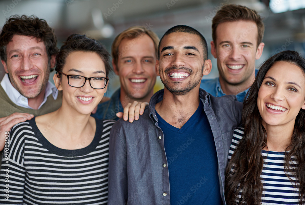Its great to be part of a team like this. Shot of a smiling group of coworkers standing in an office. Its great to be part of a team like this. Shot of a smiling group of coworkers standing in an office.
