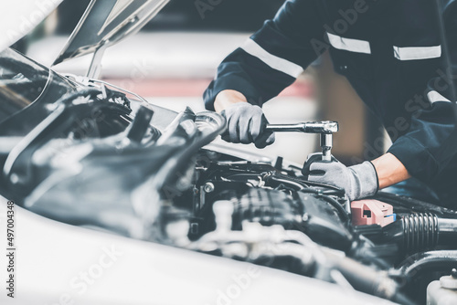 Mechanic works on the engine of the car in the garage. Repair se