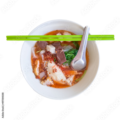 Yentafo noodles or pink noodles soup with chicken,  pig blood curd and pork meatballs on isolated white background. photo