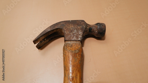 a hammer with a rusty wooden handle on the table