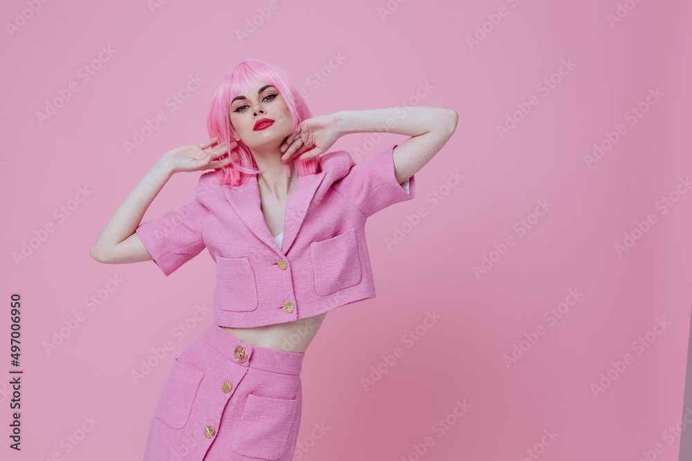 Pretty young female gestures with his hands with a pink jacket pink background unaltered
