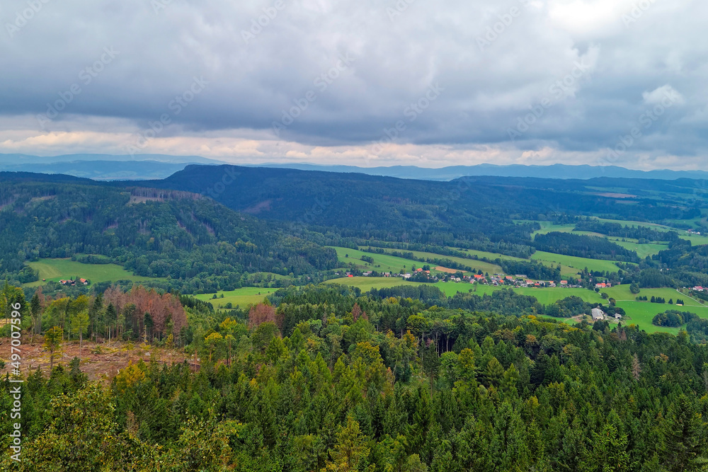 A picturesque view from a height of the green mountains on a foggy overcast morning. A picturesque view from a height of the green mountains on a foggy overcast morning.