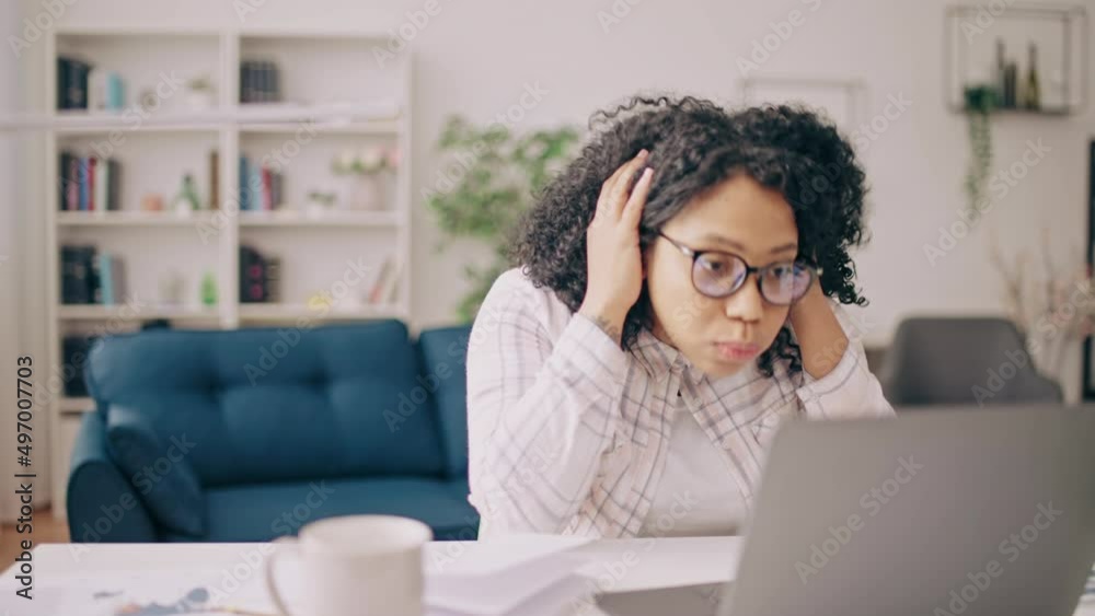 Anxious woman having problems with work tasks, correcting errors on laptop Anxious woman having problems with work tasks, correcting errors on laptop