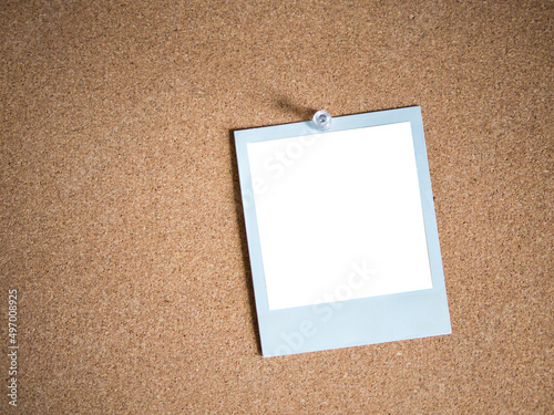 Blank white photo card template on cork board background for photo