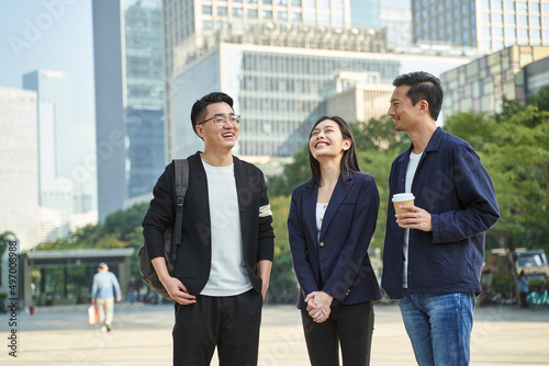 Photography three young asian adults man and woman business persons in casual wear standing