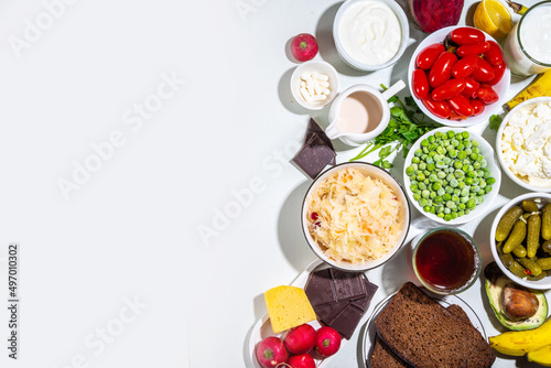 Postbiotic, prebiotic and probiotic food with medicine capsules. Set Super Healthy Fermented Food Sources, drinks, ingredients, on white marble background copy space top view