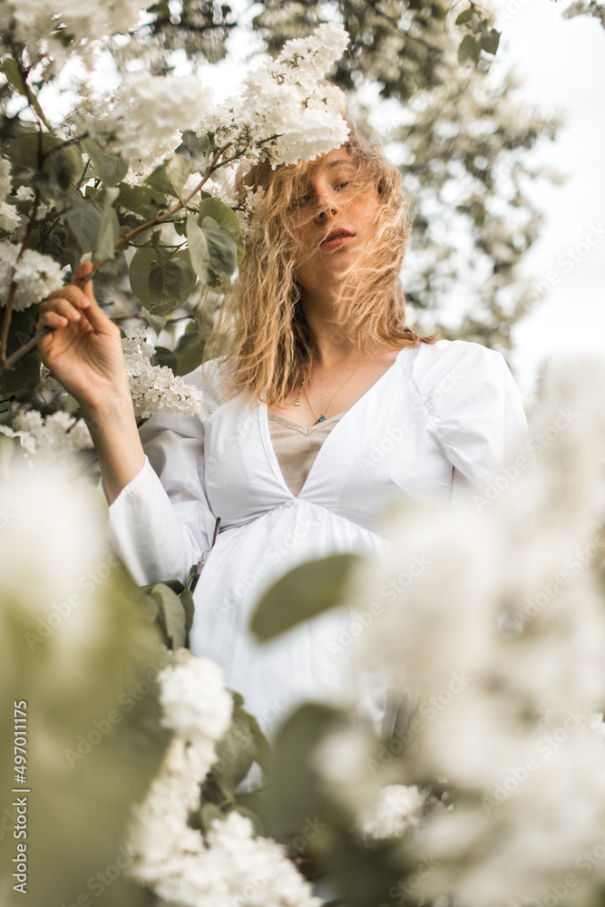 pregnant girl in the lilac garden