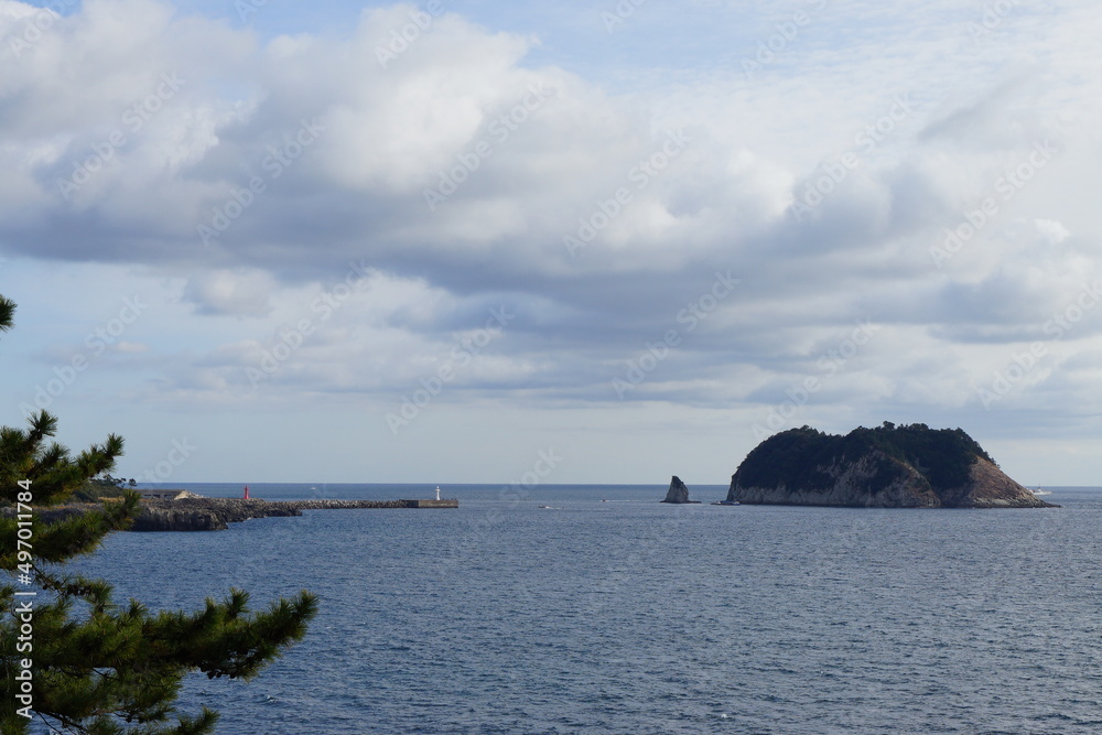 island and clouds view from seaside cliff