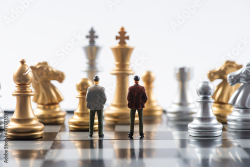 Businessman miniature standing on chessboard,Business and Competition Concept. 