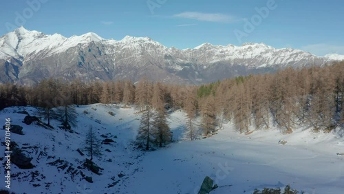 drone flying above the mountains during winter, forward movement photo