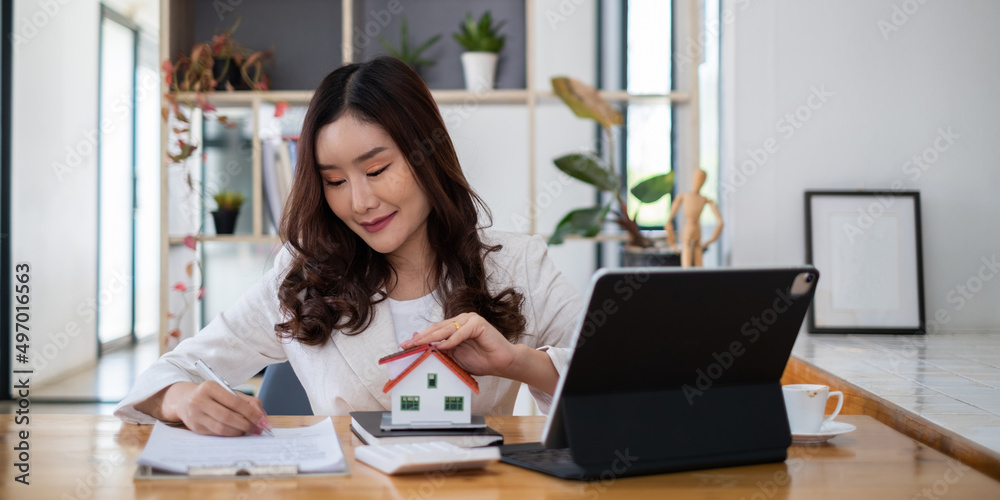 Close up of Business woman pointing and signing agreement for buying house. Bank manager concept. Close up of Business woman pointing and signing agreement for buying house. Bank manager concept.