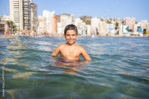 Konstfotografi Funny kid into the water on an urban beach