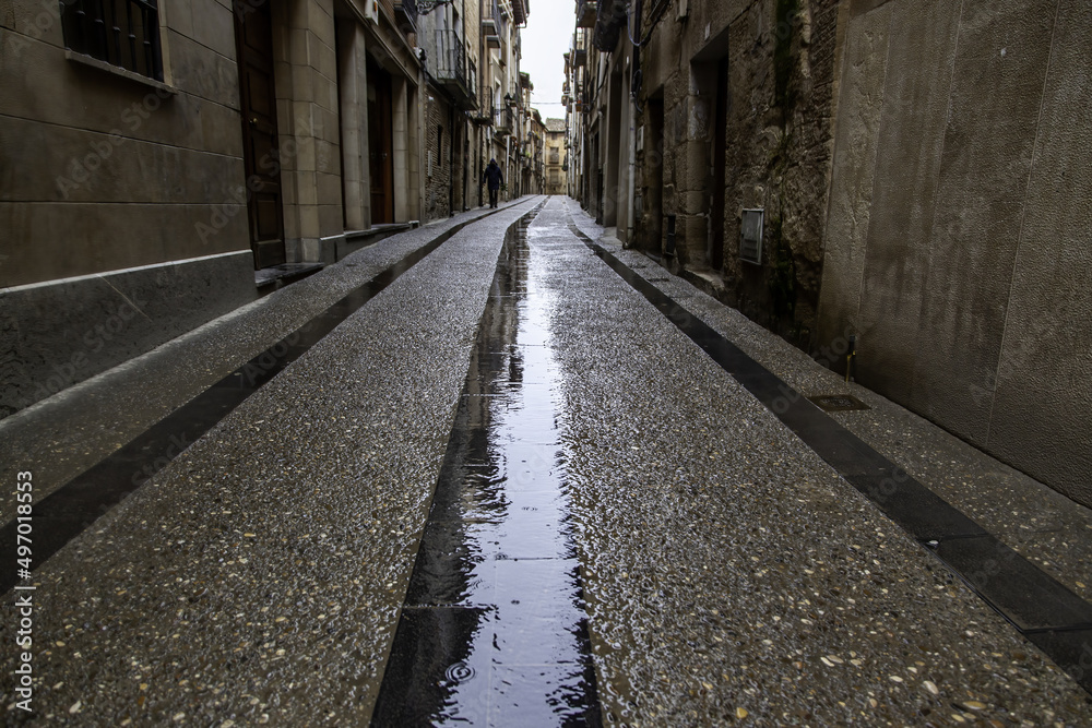 Alley with cobblestones in the rain