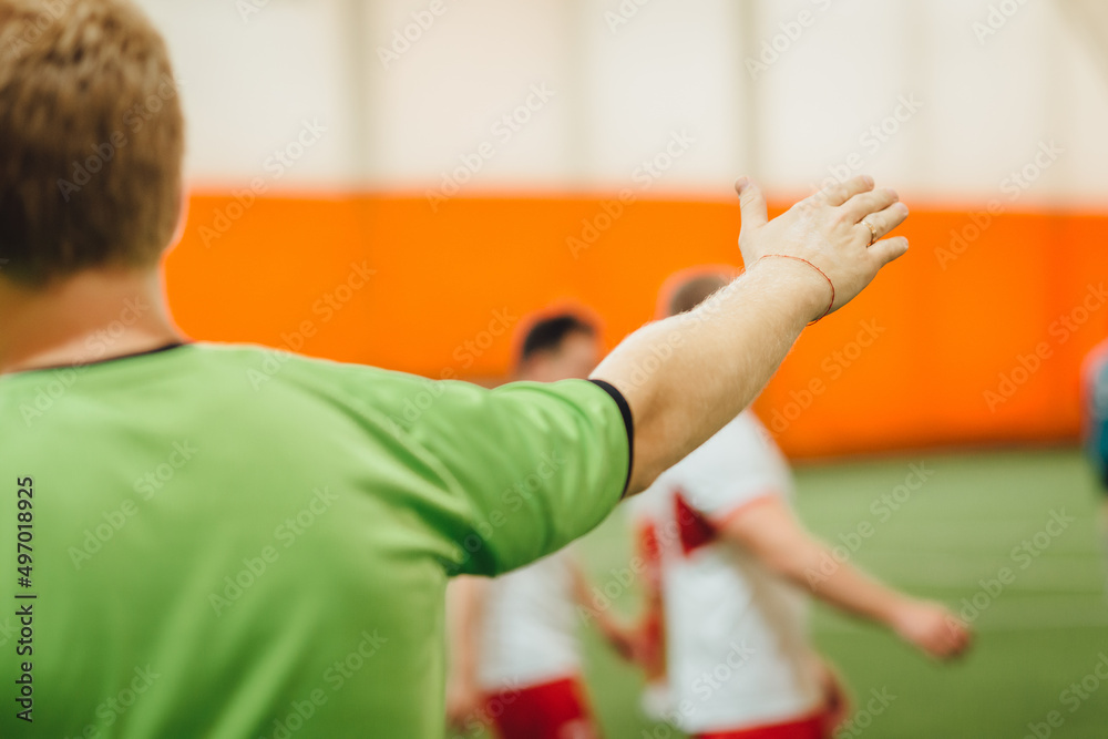 Football referee free kick hand signal during a football game on a soccer field. Selective focus Football referee free kick hand signal during a football game on a soccer field. Selective focus
