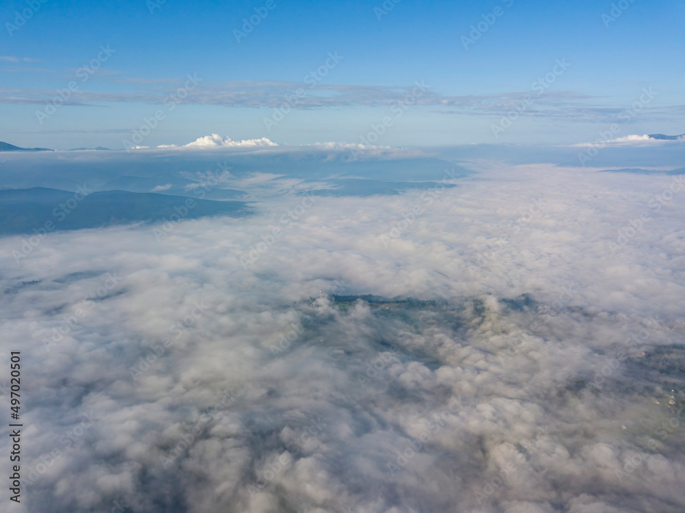 High flight above the clouds in the mountains. Aerial drone view. High flight above the clouds in the mountains. Aerial drone view.