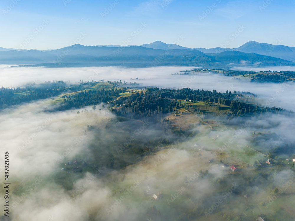 Morning mist in Ukrainian Carpathian mountains. Aerial drone view.