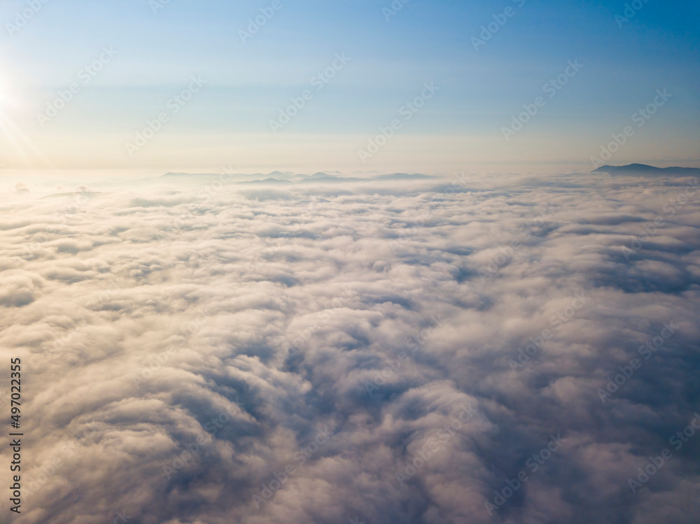 High flight above the clouds. Aerial drone view.