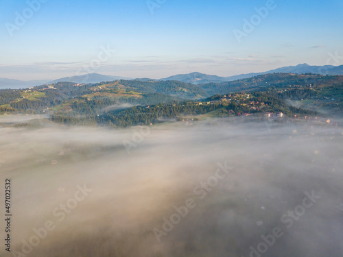 Morning mist in Ukrainian Carpathian mountains. Aerial drone view.