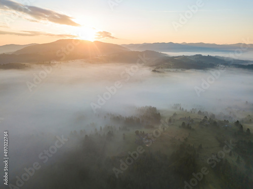 Sunrise over the fog in the Ukrainian Carpathians. Aerial drone view.