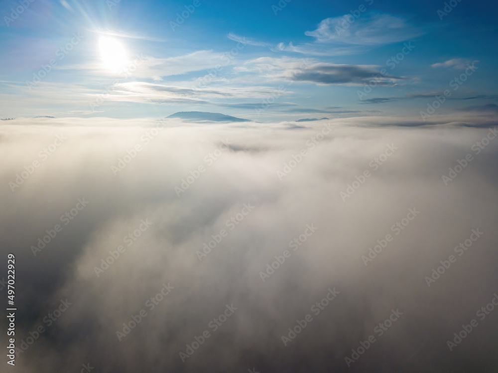 Fototapeta premium High flight above the clouds. Aerial drone view.