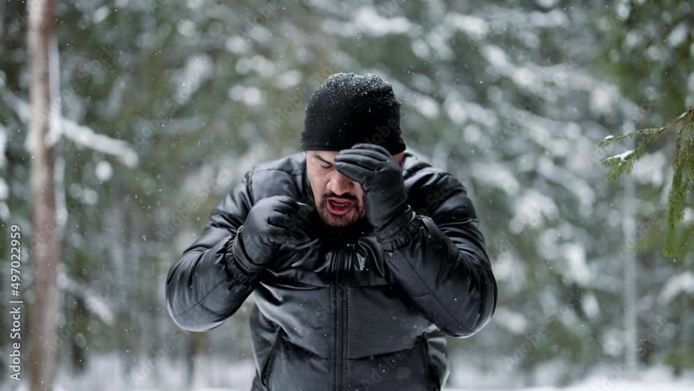 middle-aged fighter is training alone in winter forest, practicing hand punches, portrait middle-aged fighter is training alone in winter forest, practicing hand punches, portrait