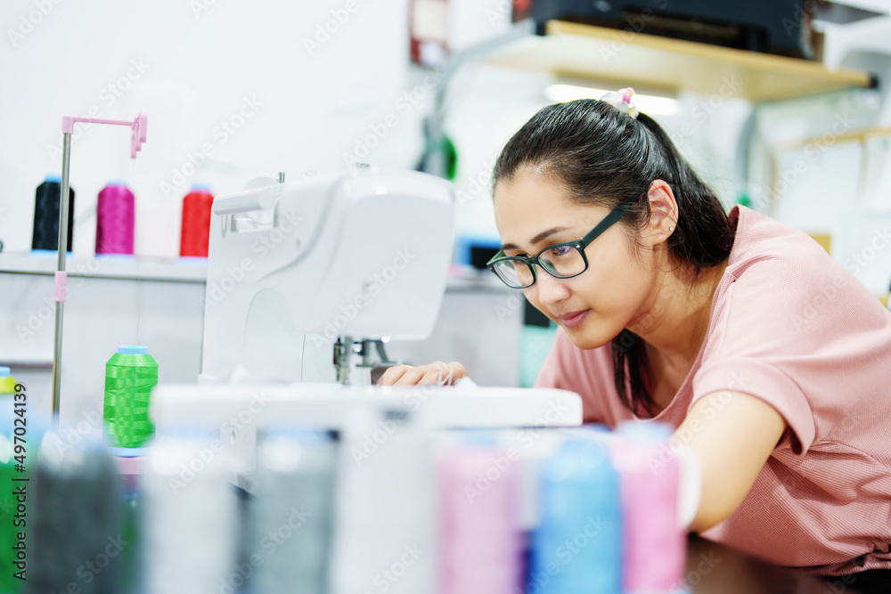 Embroidery, handicrafts, hobbies, SME business, family business, Portrait of Asian female designers are doing by designing patterns using automatic embroidery machines by customer order. Embroidery, handicrafts, hobbies, SME business, family business, Portrait of Asian female designers are doing by designing patterns using automatic embroidery machines by customer order.