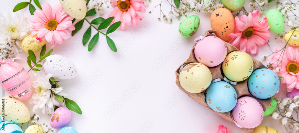 Colorful eggs and flowers on a white background. Easter design in pastel colors with space for text. Holiday banner Colorful eggs and flowers on a white background. Easter design in pastel colors with space for text. Holiday banner