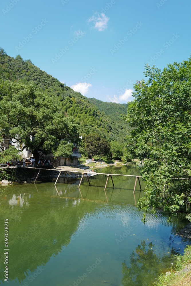 Old Chinese village with mountain and river natural surrounding simple bridge Old Chinese village with mountain and river natural surrounding simple bridge