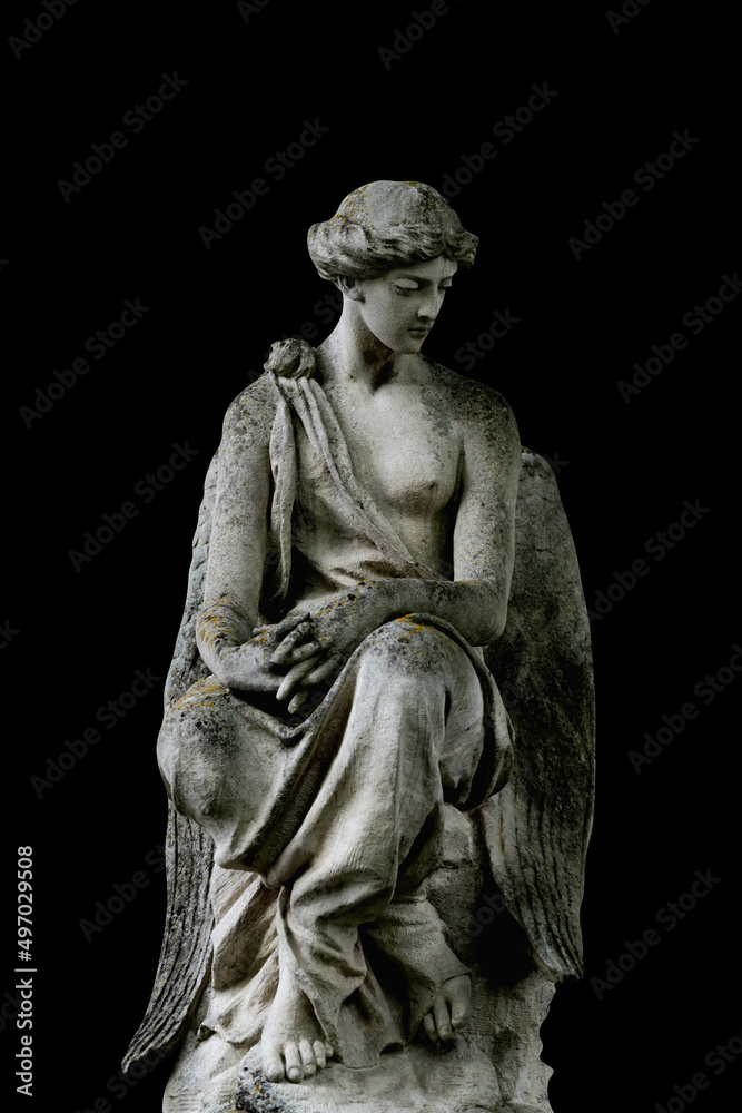 Angel. Ancient stone statue isolated on black background.