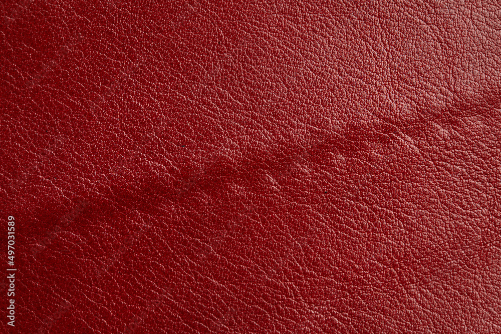 Fototapeta premium Red leather texture background. Luxury genuine textile surface material wallpaper with furniture backdrop. Close up of fashion fabric