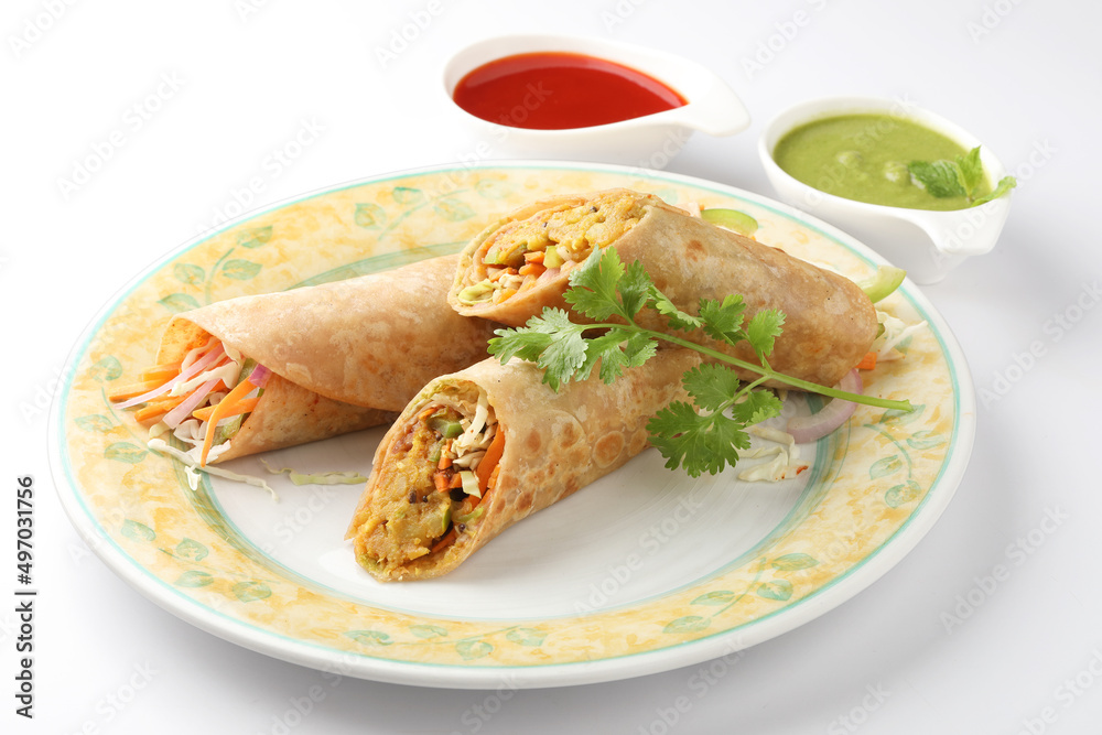 Indian Frankie Veg chapati Wrap / Kathi Roll, served in a plate with sauce & mint chutney. selective focus Indian Frankie Veg chapati Wrap / Kathi Roll, served in a plate with sauce & mint chutney. selective focus