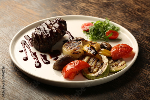 delicious grilled beef steak with vegetable salad served on plate 