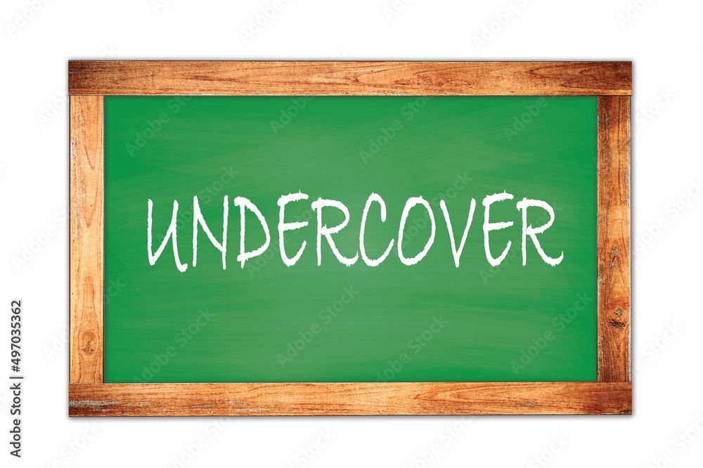 UNDERCOVER text written on green school board. UNDERCOVER text written on green school board.