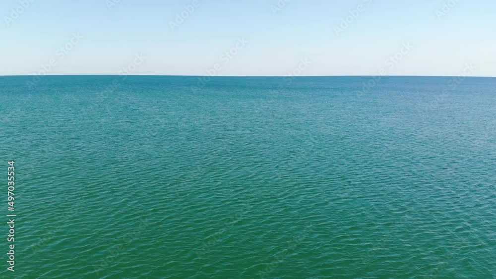 The transparent surface of the sea and algae with stones under its surface. Aerial view of ocean surface The transparent surface of the sea and algae with stones under its surface. Aerial view of ocean surface