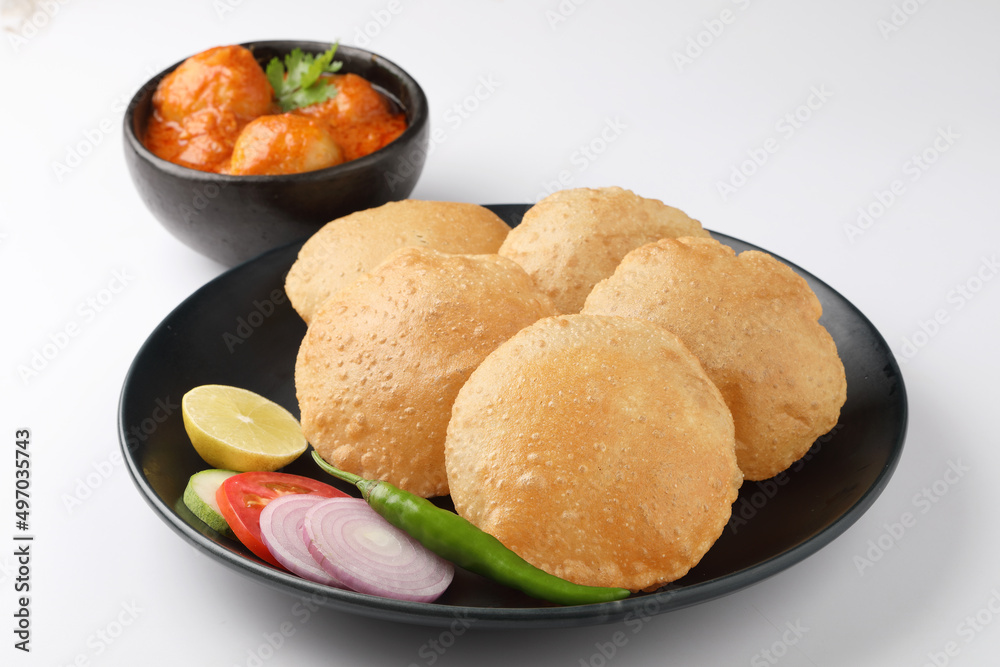 Puri and Chole traditional Indian food
Indian dish spicy Chick Peas curry also known as Chola/Chana Masala or commonly Chole, served served with fried puri or poori Puri and Chole traditional Indian food
Indian dish spicy Chick Peas curry also known as Chola/Chana Masala or commonly Chole, served served with fried puri or poori