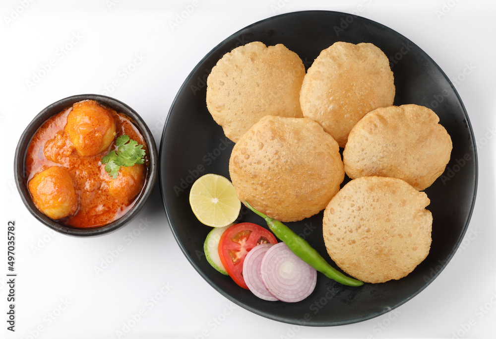 Puri and Chole traditional Indian food
Indian dish spicy Chick Peas curry also known as Chola/Chana Masala or commonly Chole, served served with fried puri or poori Puri and Chole traditional Indian food
Indian dish spicy Chick Peas curry also known as Chola/Chana Masala or commonly Chole, served served with fried puri or poori