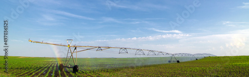 Agricultural irrigation system watering crops in summer © Solid photos