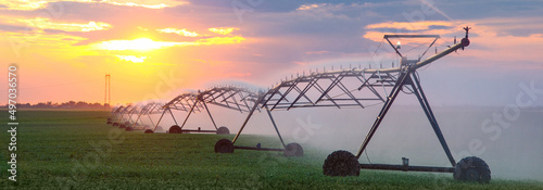 Agricultural irrigation system watering crops in summer