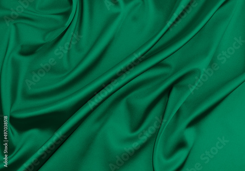 Green satin fabric as background photo