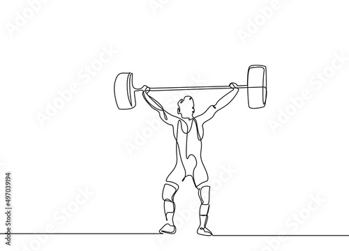 a weightlifter in weightlifting clothes lifts weights in a competition