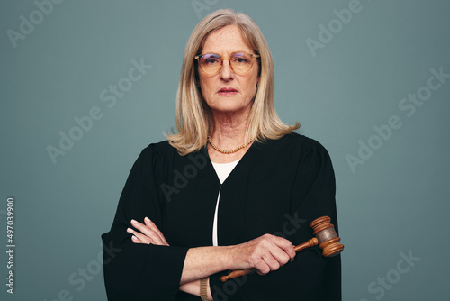Mature judge looking at the camera in a studio