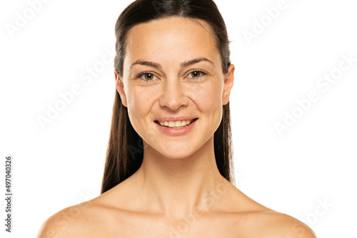 a young happy woman without makeup with long hair on a white background
