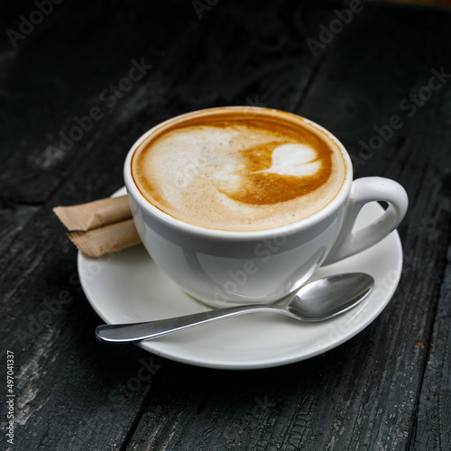 cup of coffee on a wooden black table 