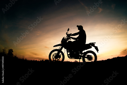 Men's silhouettes and touring motocross bikes. Park to relax in the mountains in the evening. adventure travel and leisure concept