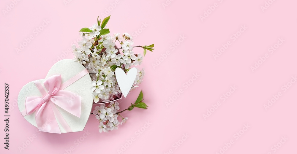 gift box with white heart and cherry flowers on abstract pink background. spring season, festive composition. romantic gift for women. top view. copy space