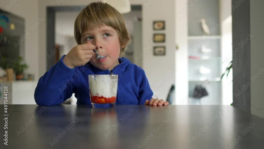 toddler boy eating strawberries and cream toddler boy eating strawberries and cream