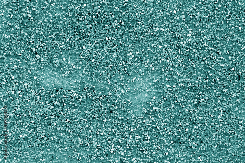 Obraz premium Wall made of small crushed stones and concrete in cyan tone.